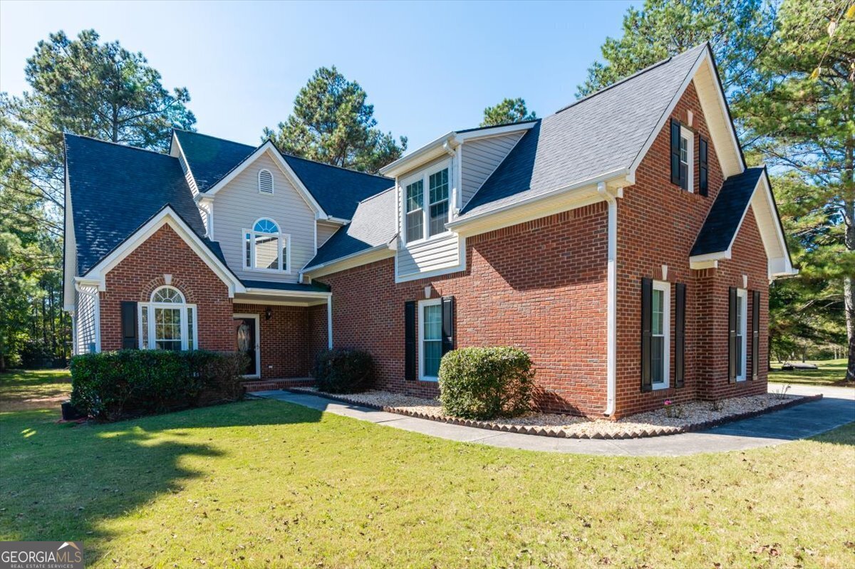 a front view of a house with a yard