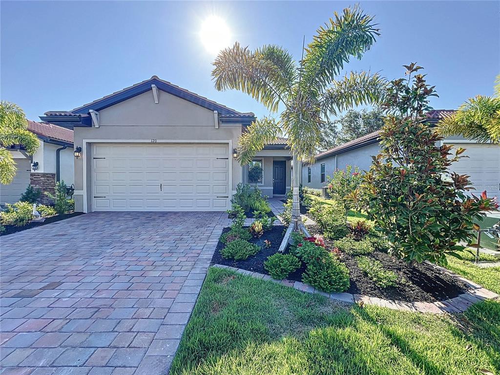 a front view of a house with a yard and garage