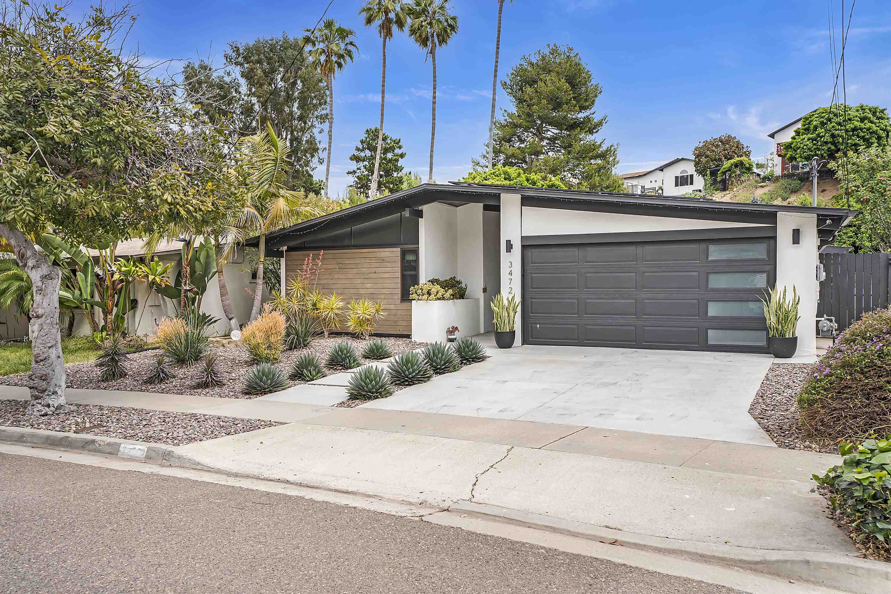 a view of a house with a yard and garage