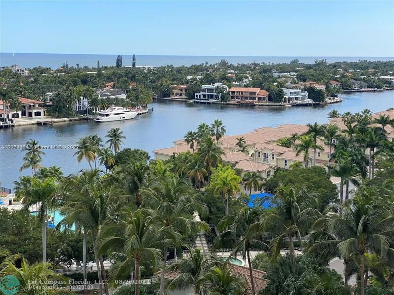 an aerial view of residential houses with outdoor space and lake view