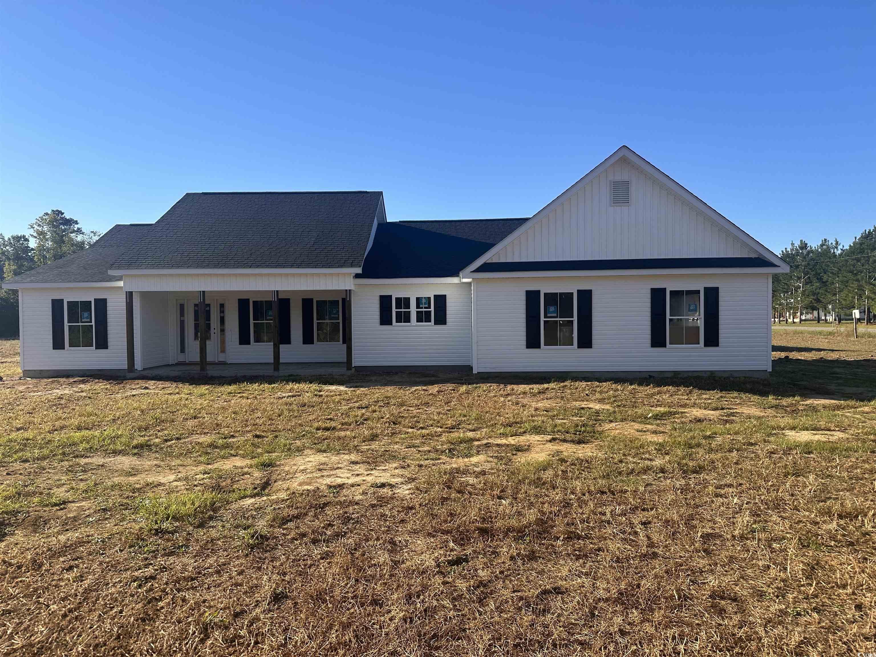 Rear view of house with a yard