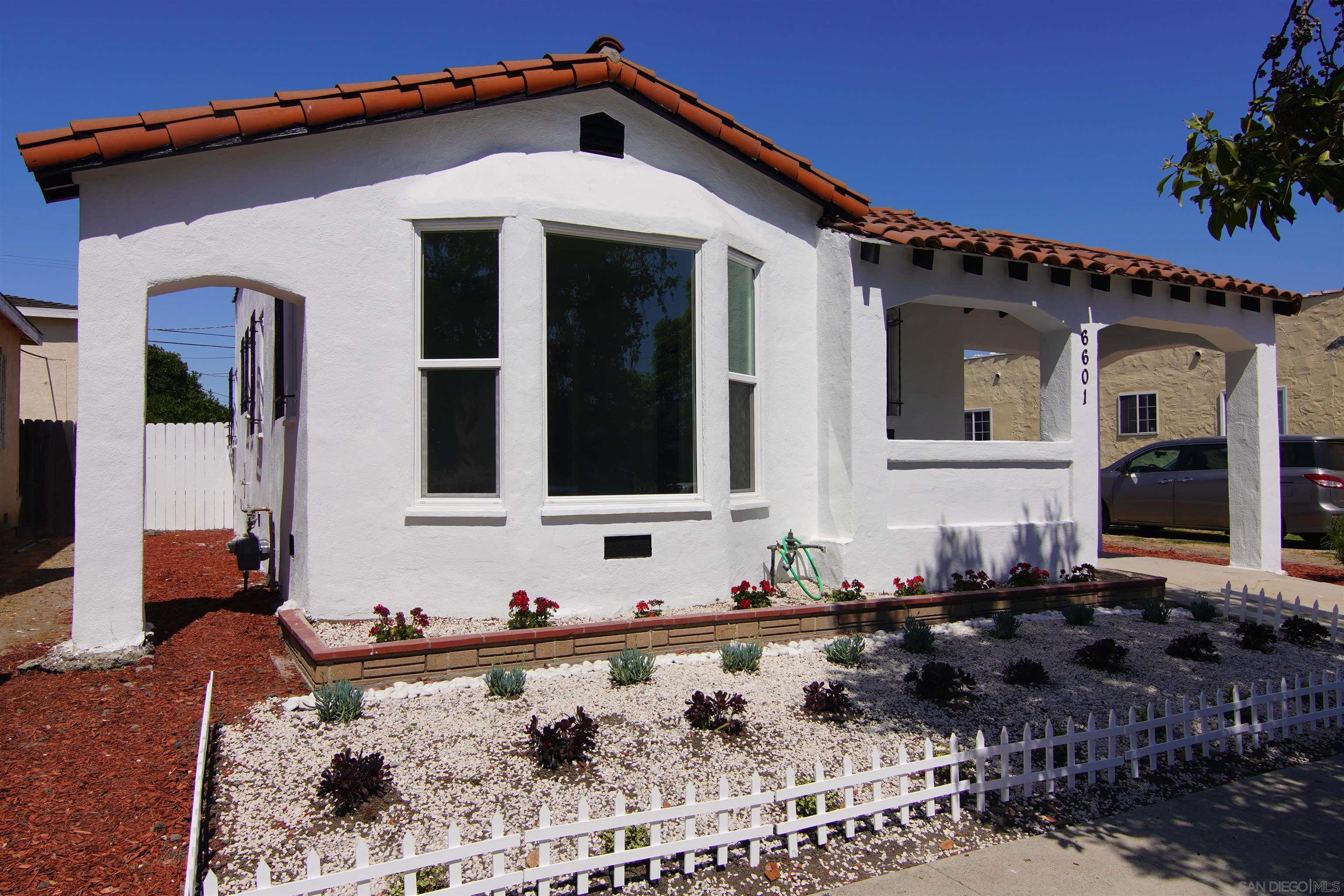 a front view of a house with large windows