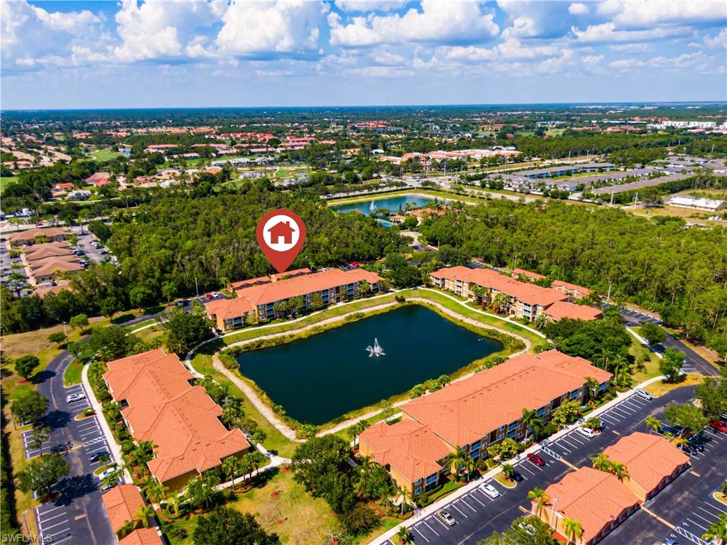 Birds eye view of property with a water view