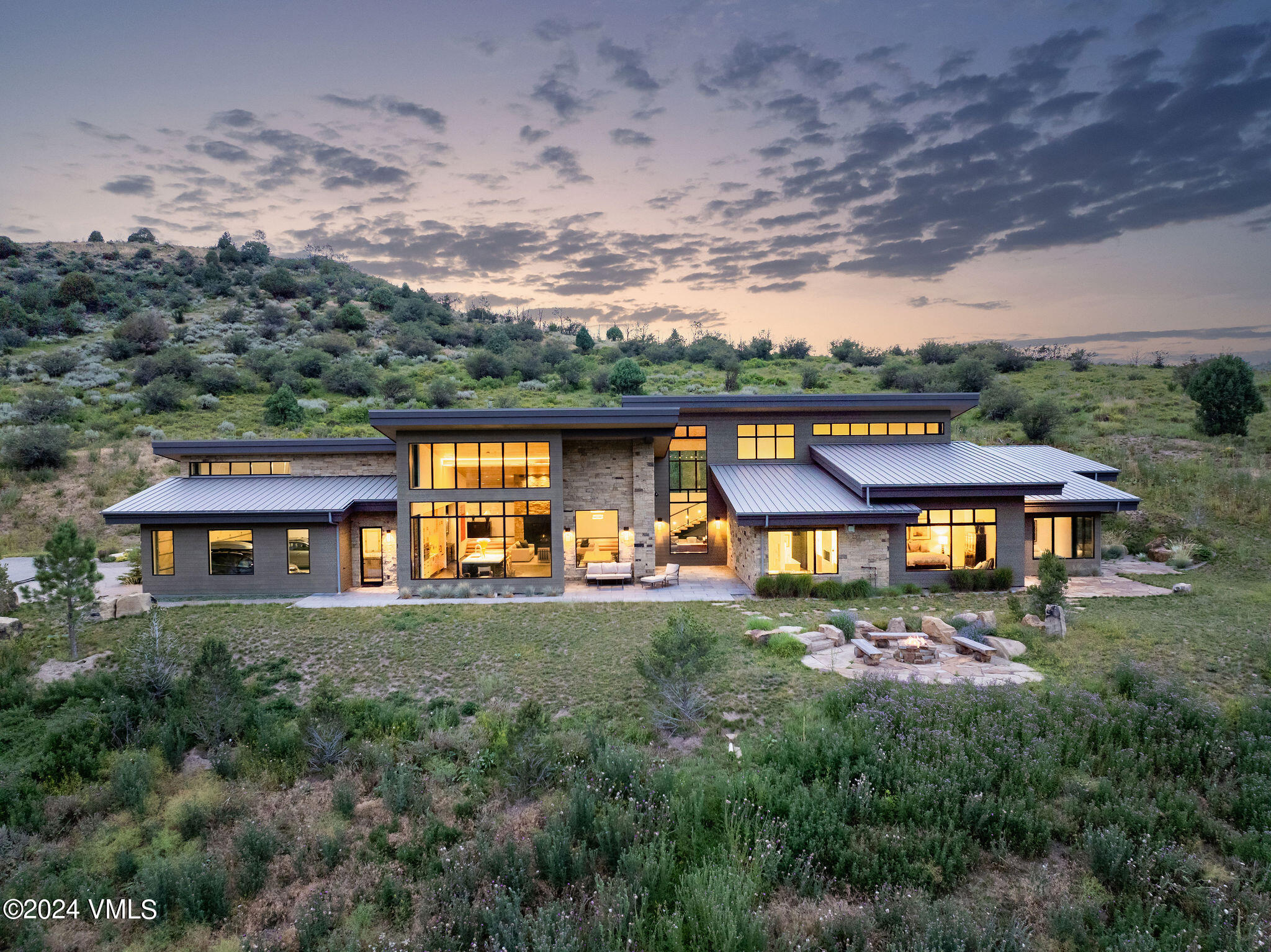 an aerial view of a house with swimming pool garden and mountain view