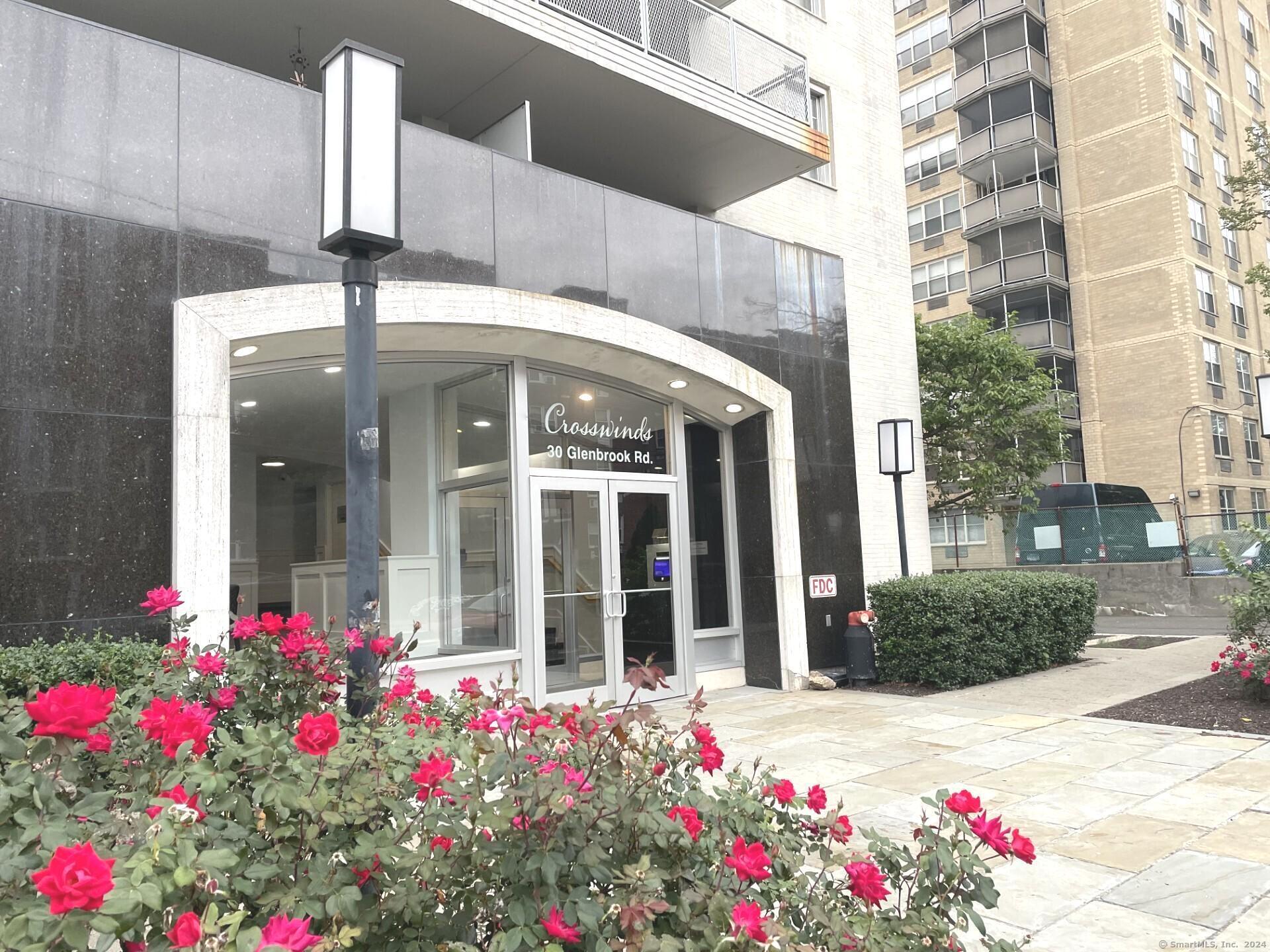 a front view of a building with flowers