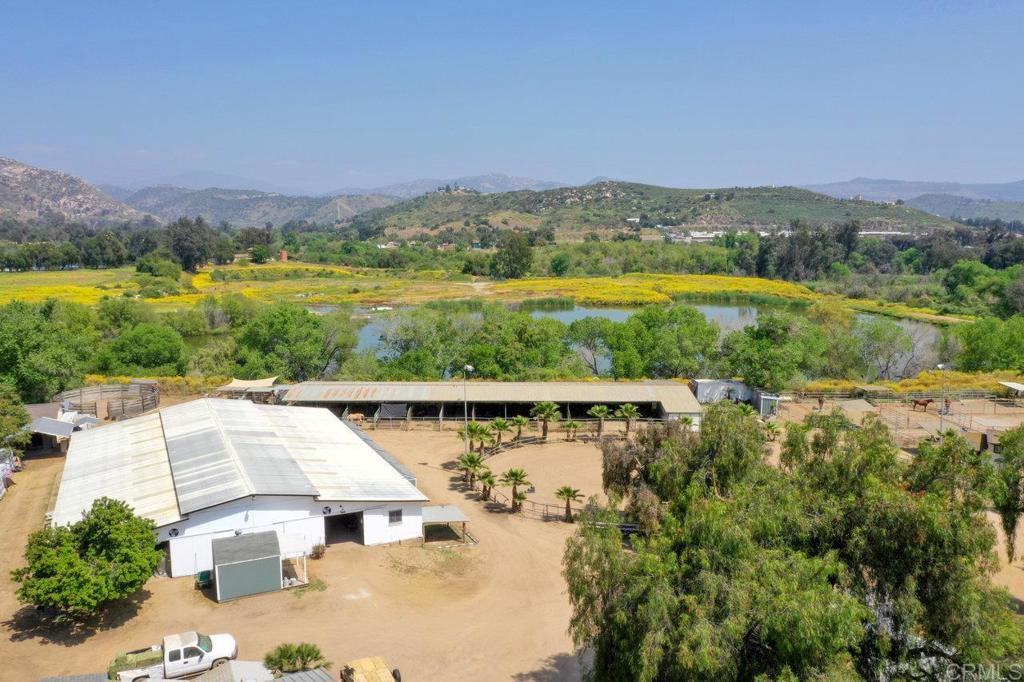 an aerial view of residential houses with outdoor space and river