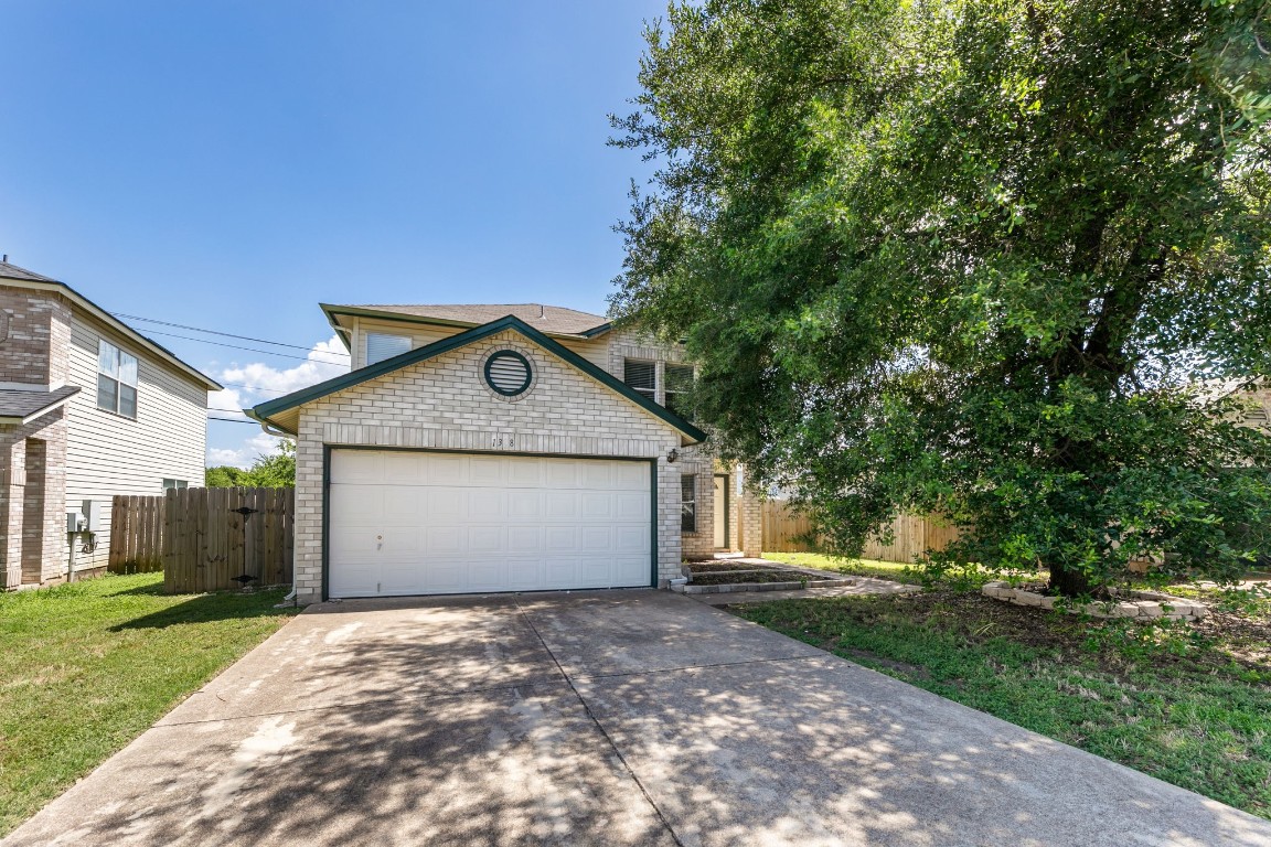 a front view of house with yard and trees