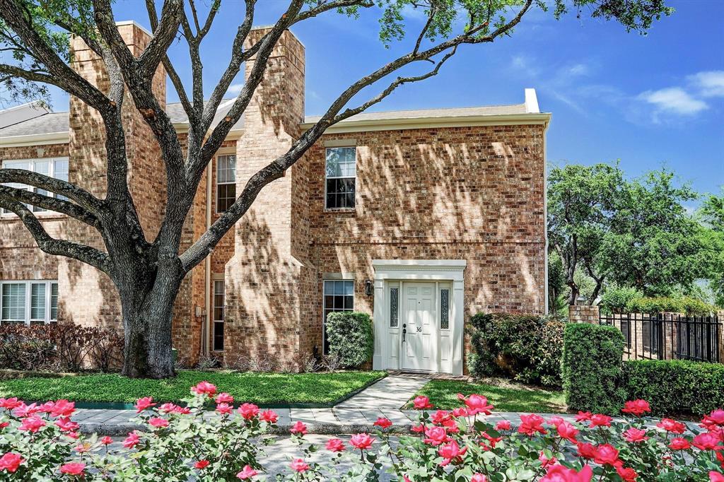 a flower garden is sitting in front of a house