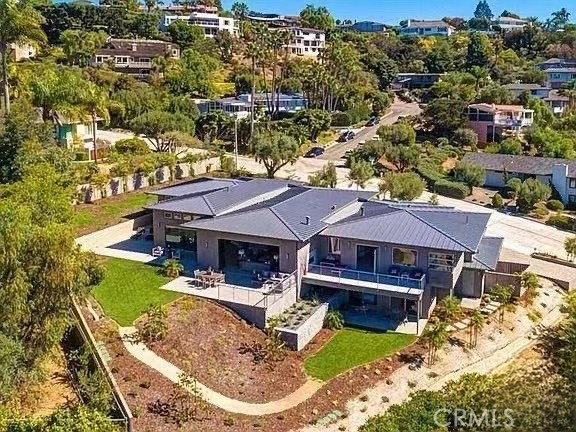 an aerial view of a house with swimming pool and lake view