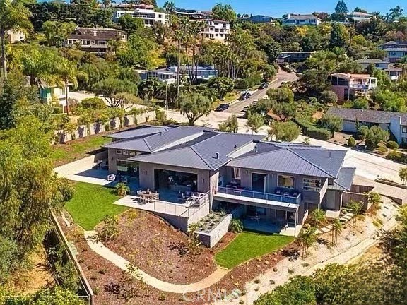 an aerial view of a house with swimming pool and lake view