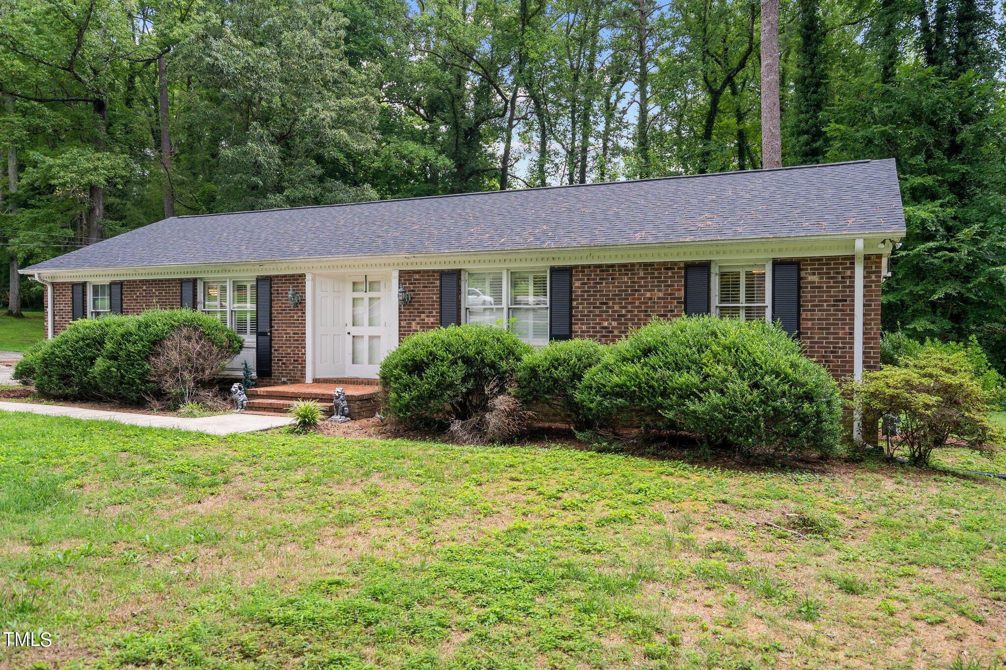 a view of a house with a yard and plants