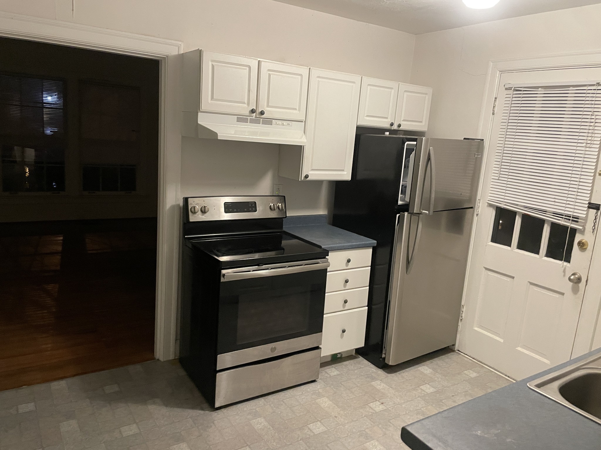 a kitchen with stainless steel appliances a stove a refrigerator and a cabinets