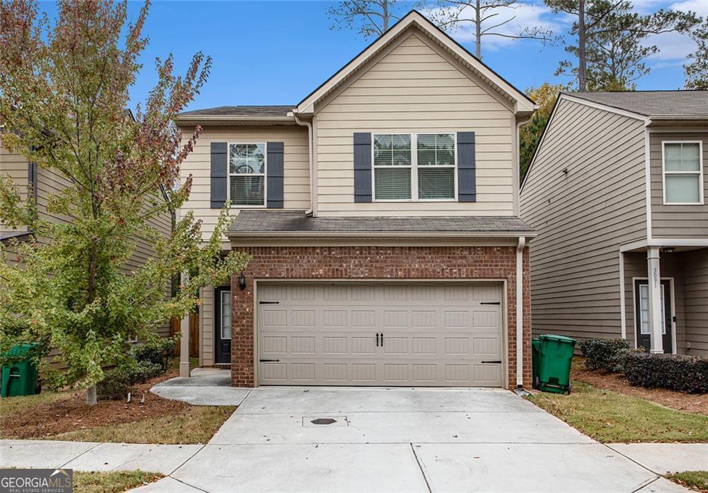 a front view of a house with garage