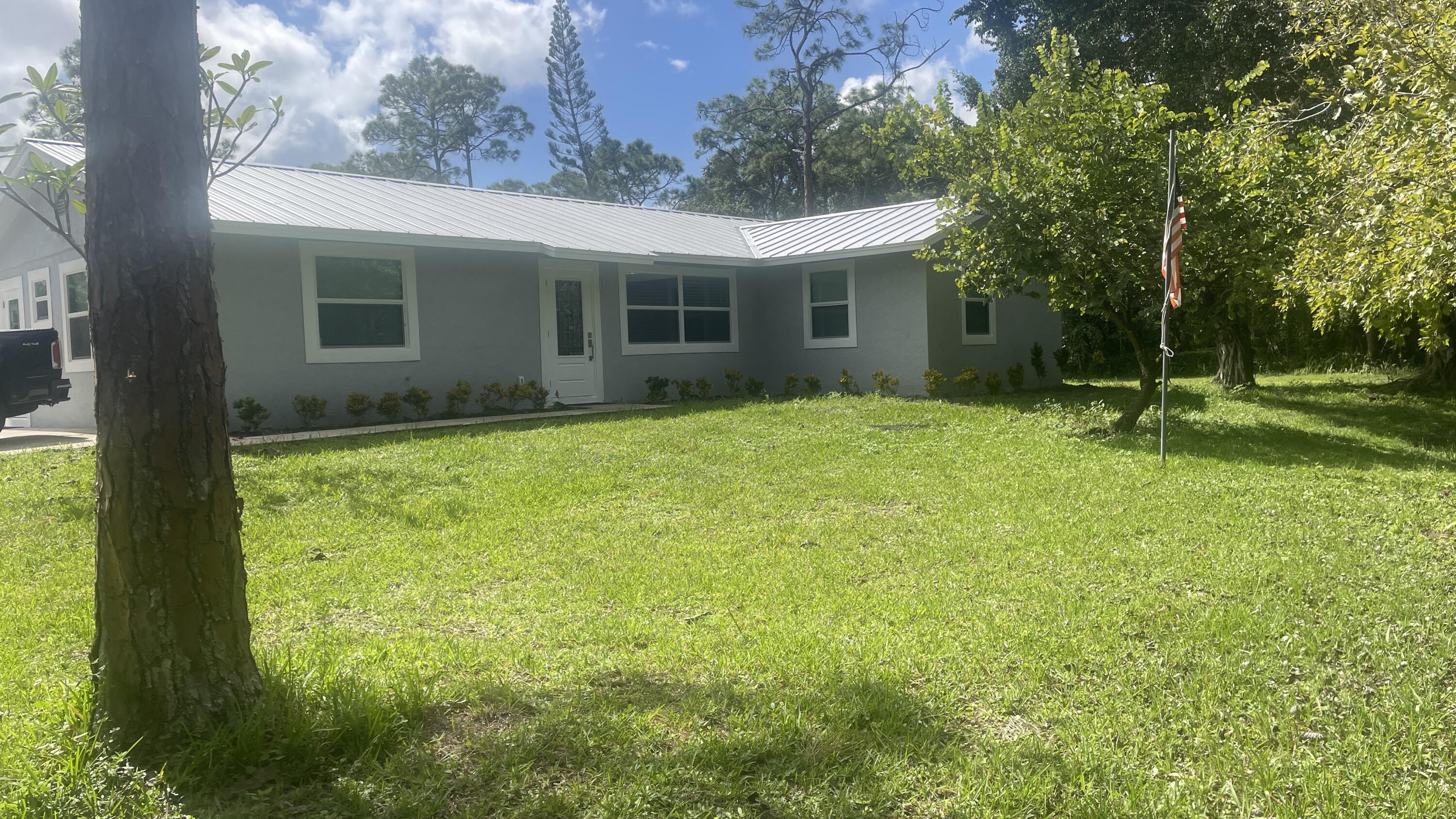 a view of a house with a backyard