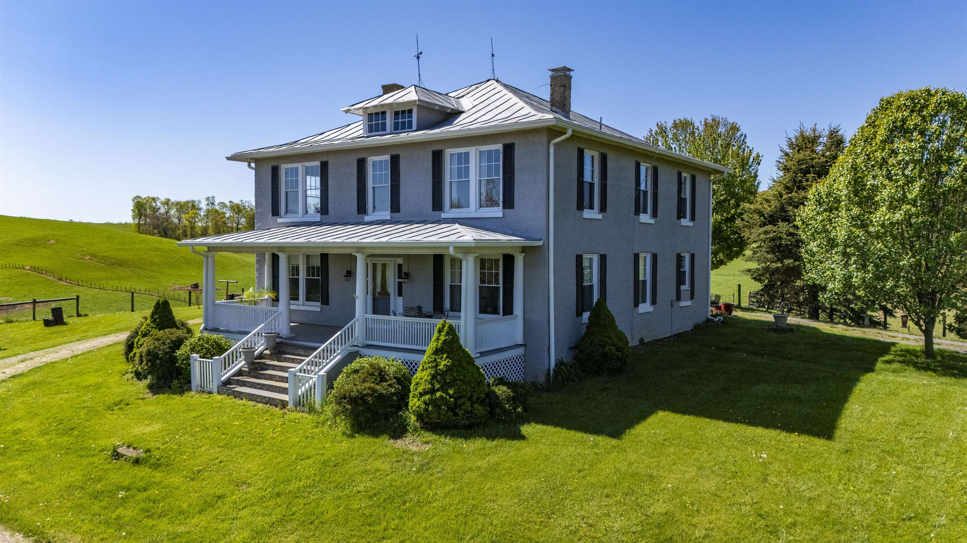 a front view of house with yard and green space