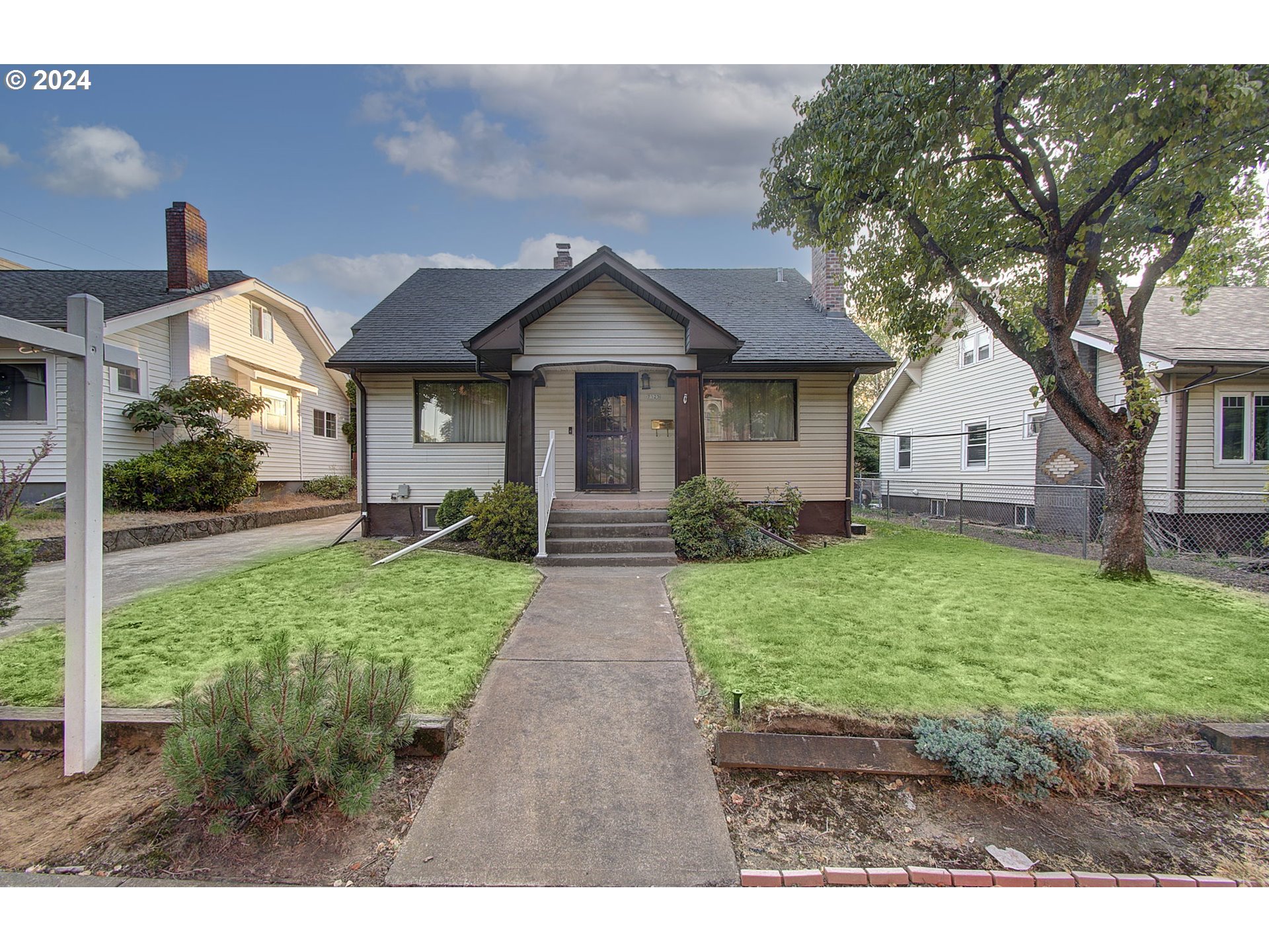 a front view of a house with garden