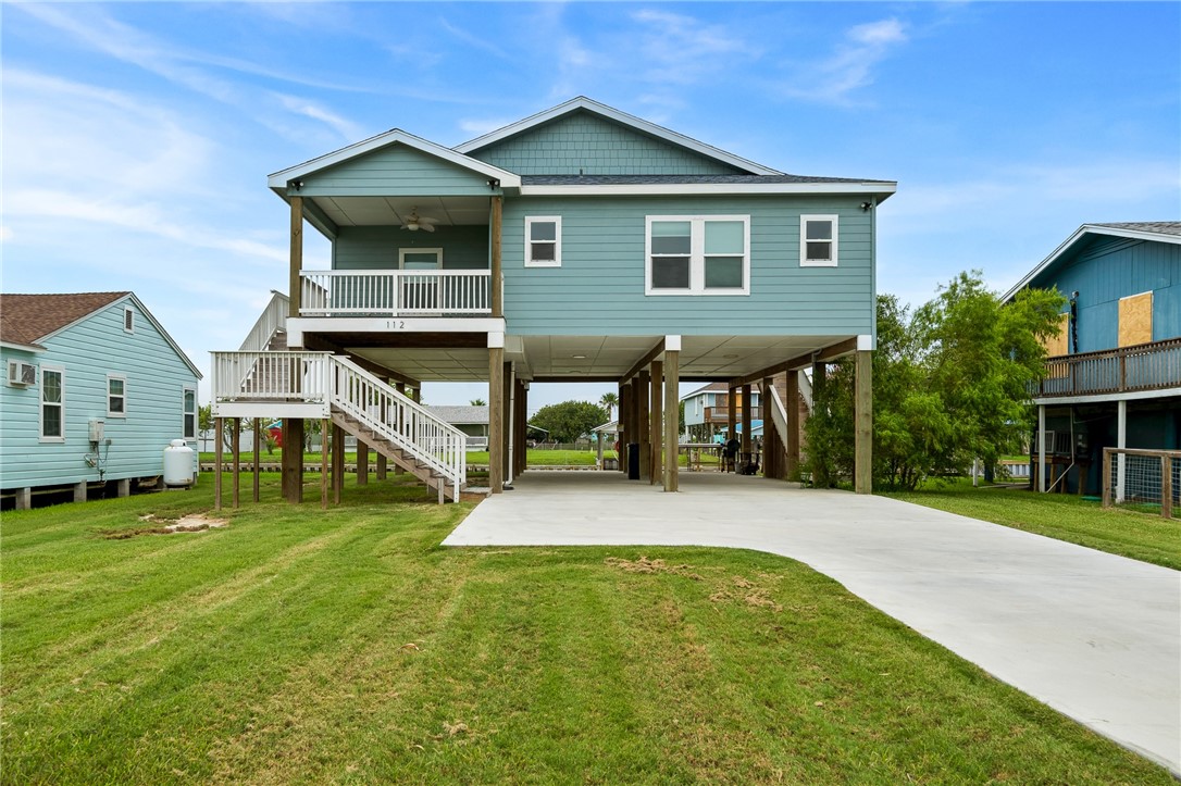 a view of a house with a yard and deck