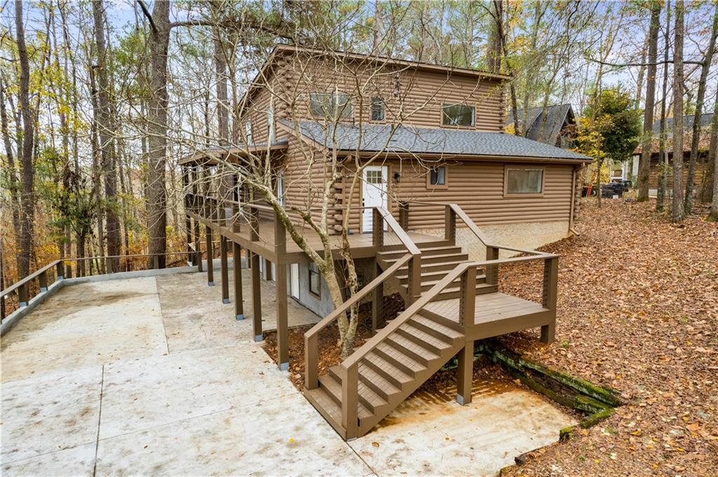 a view of a house with backyard and sitting area