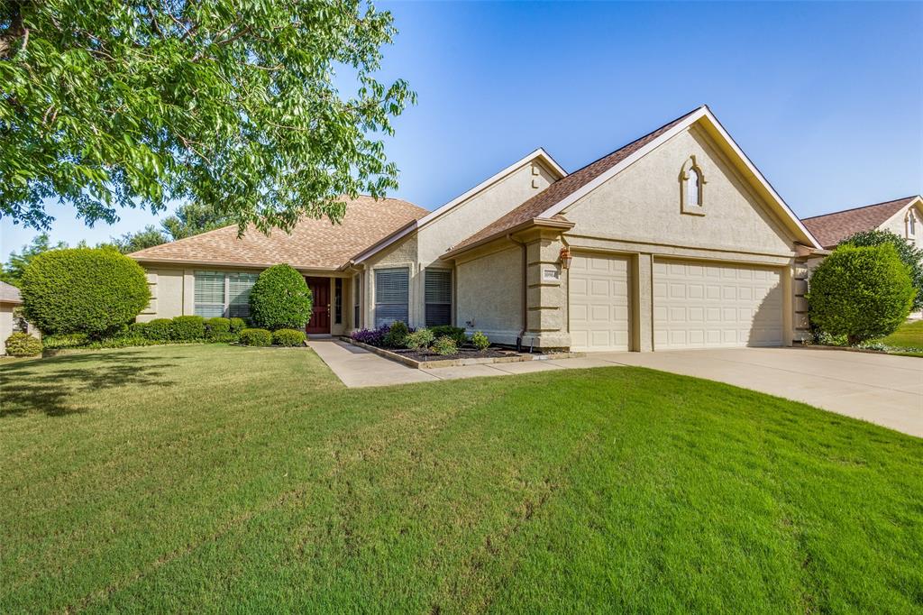 a front view of a house with yard and green space