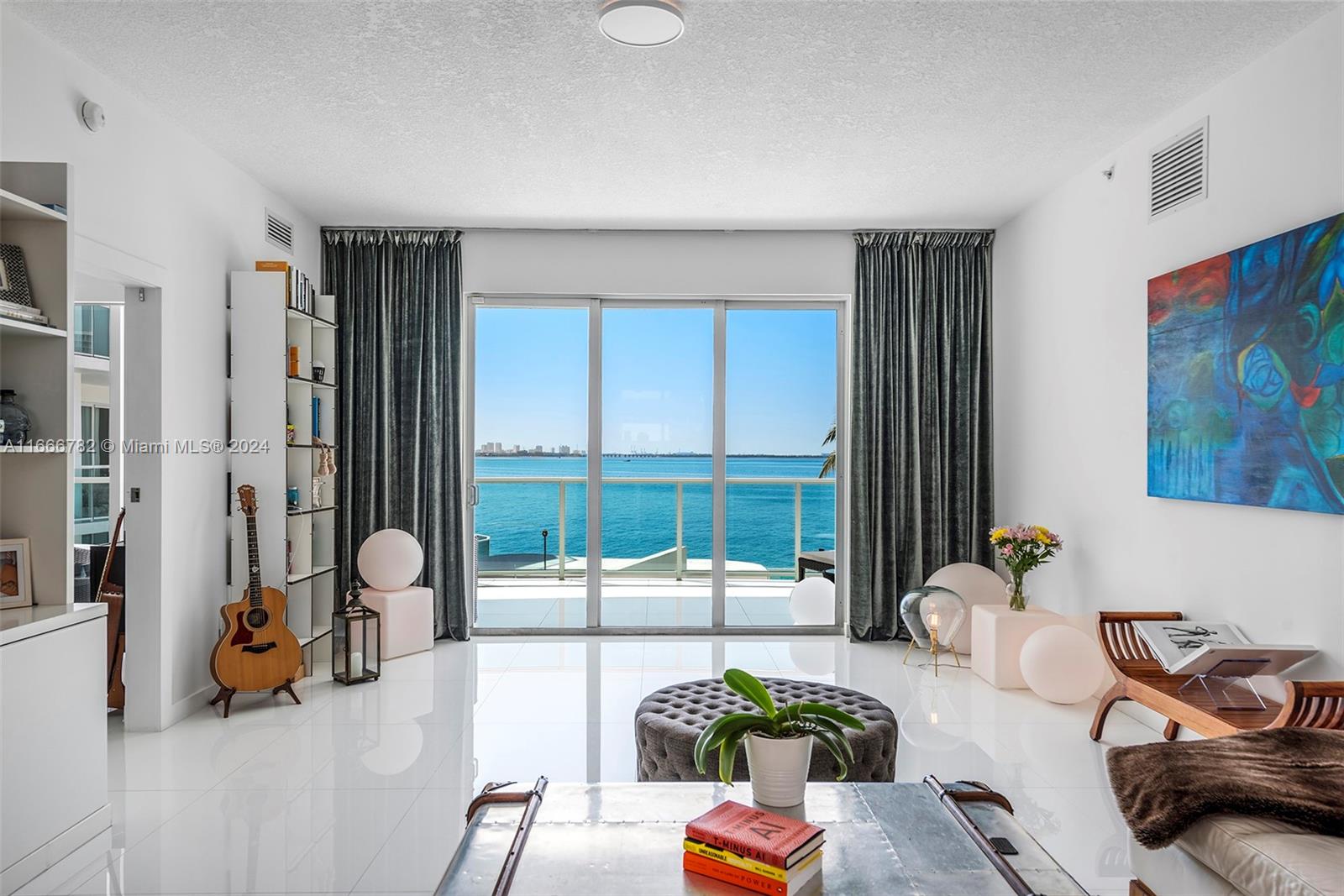 a living room with furniture and a floor to ceiling window