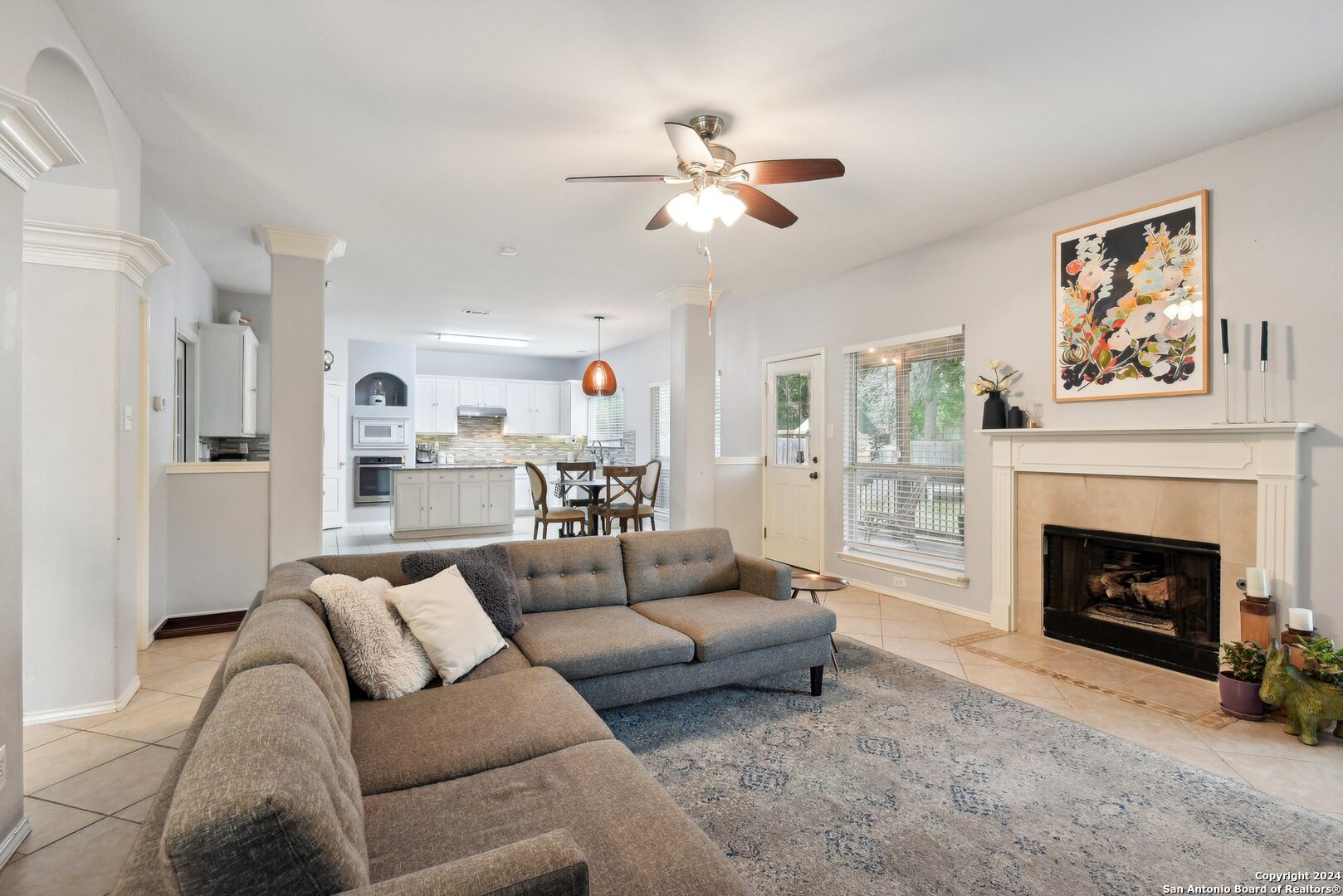 a living room with furniture and a fireplace