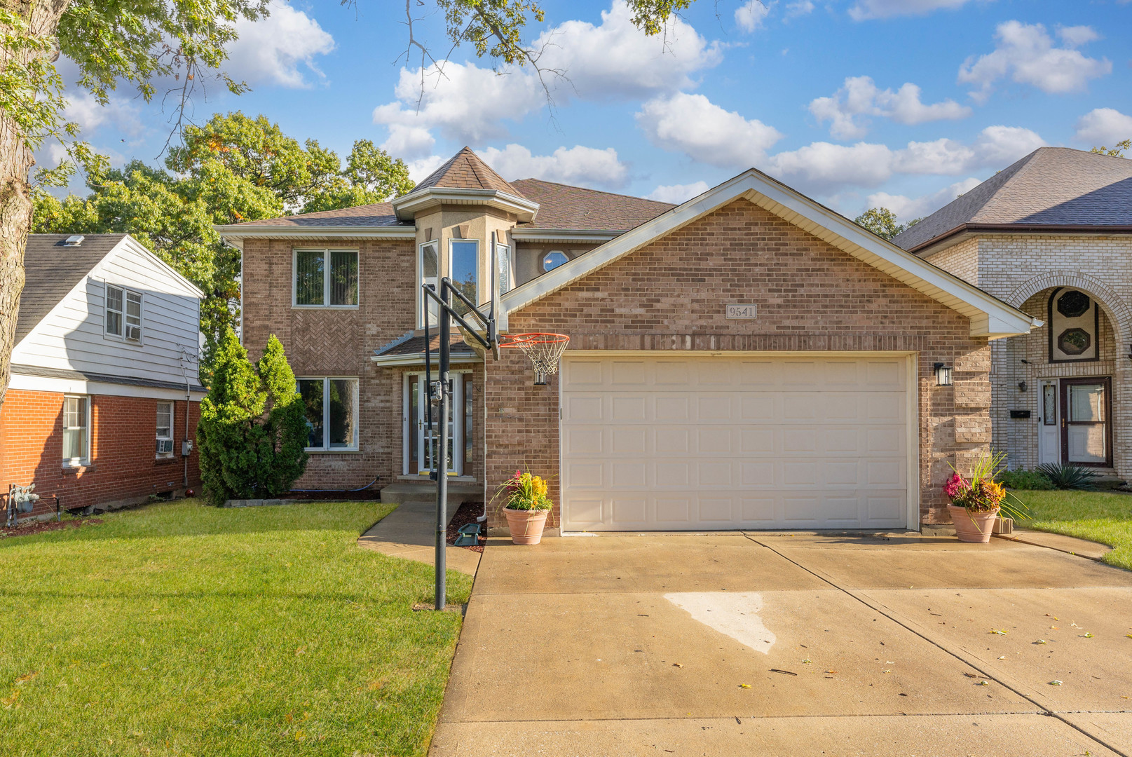 a front view of a house with a yard and garage