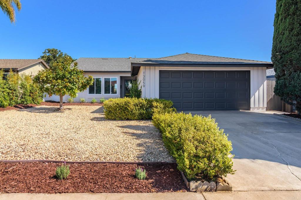 a front view of a house with a yard and a garage