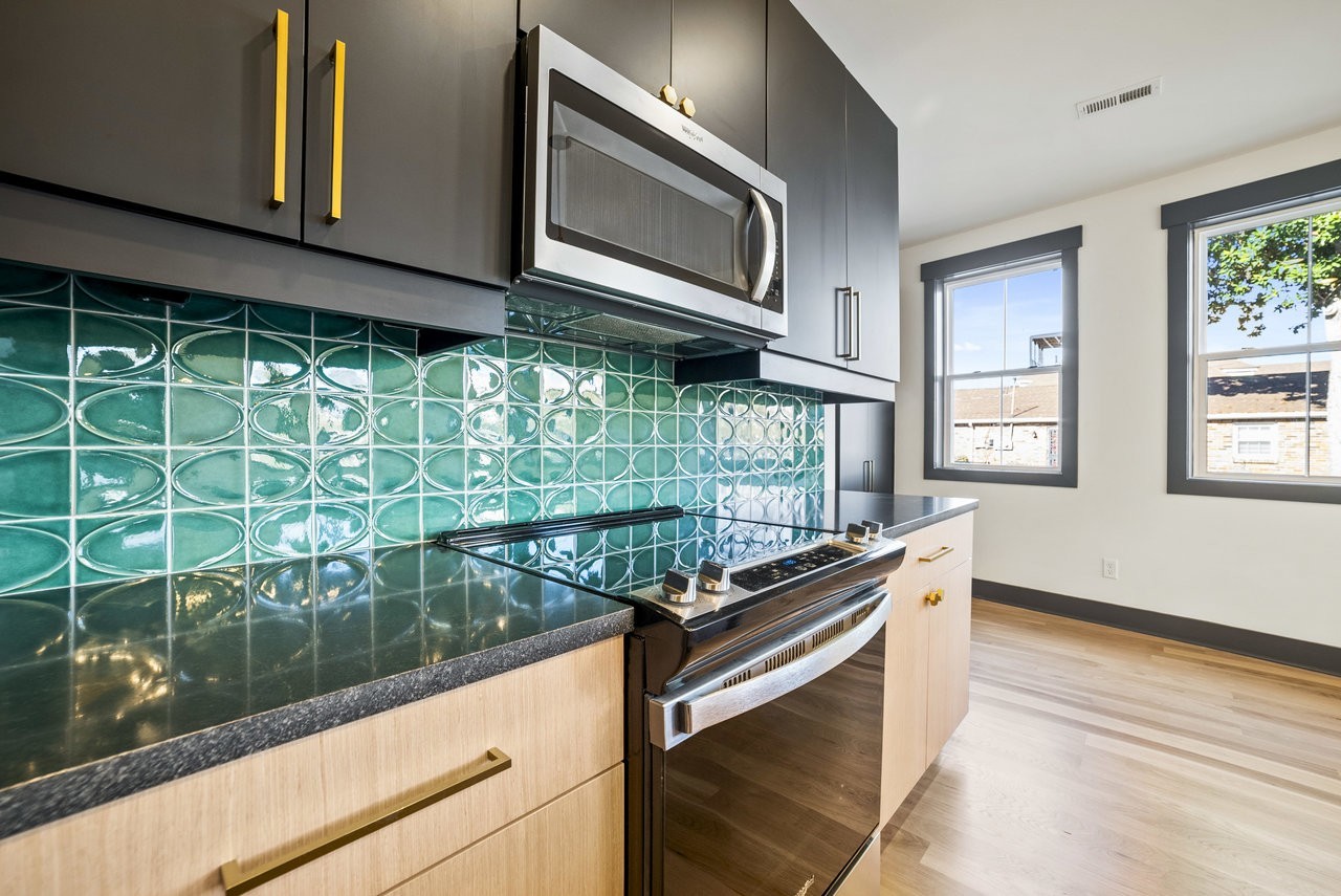 a kitchen with stainless steel appliances granite countertop a stove and a sink