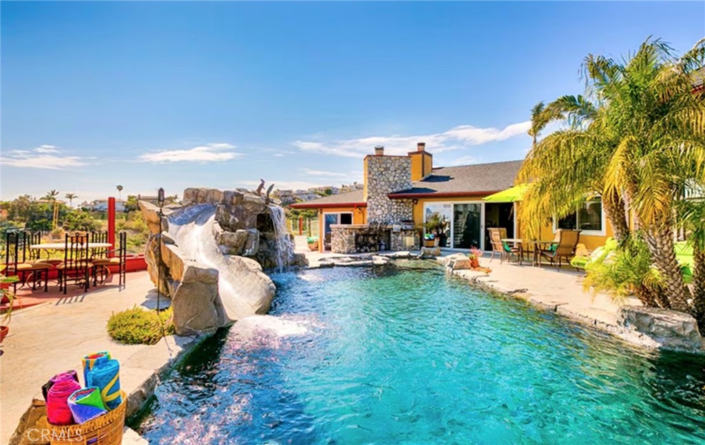 a view of a house with swimming pool and furniture