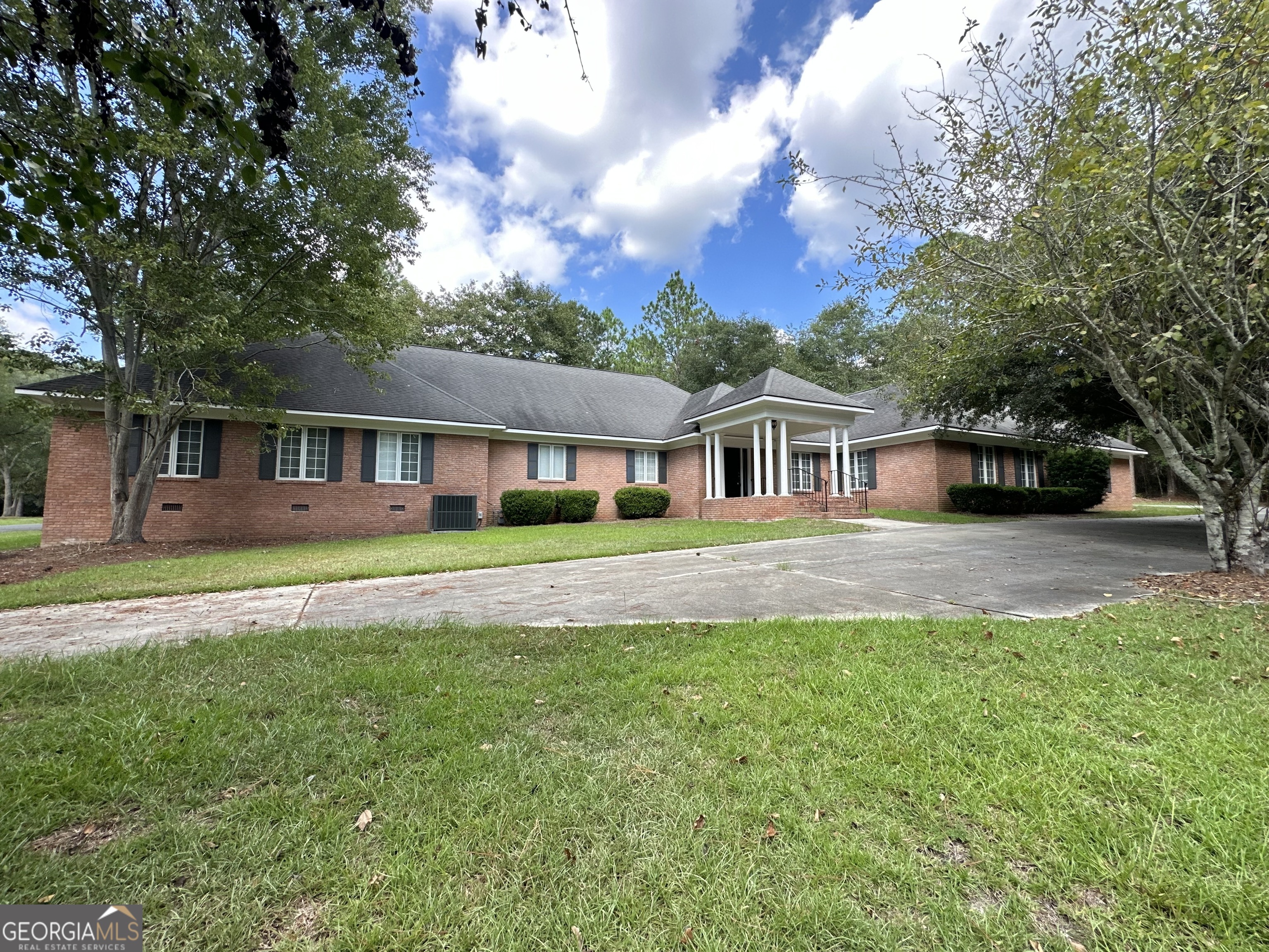 a front view of house with yard and green space