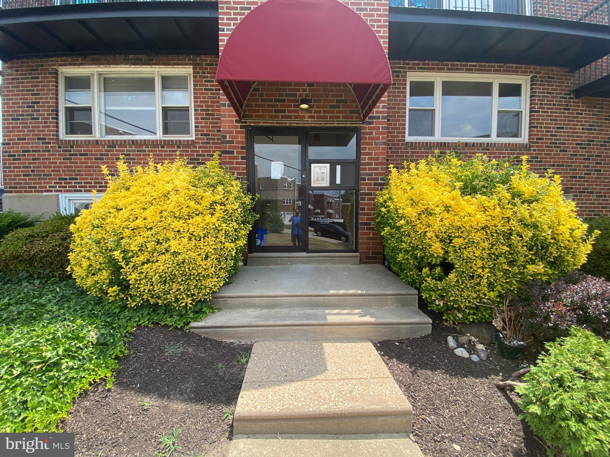 a view of a brick house with potted plants