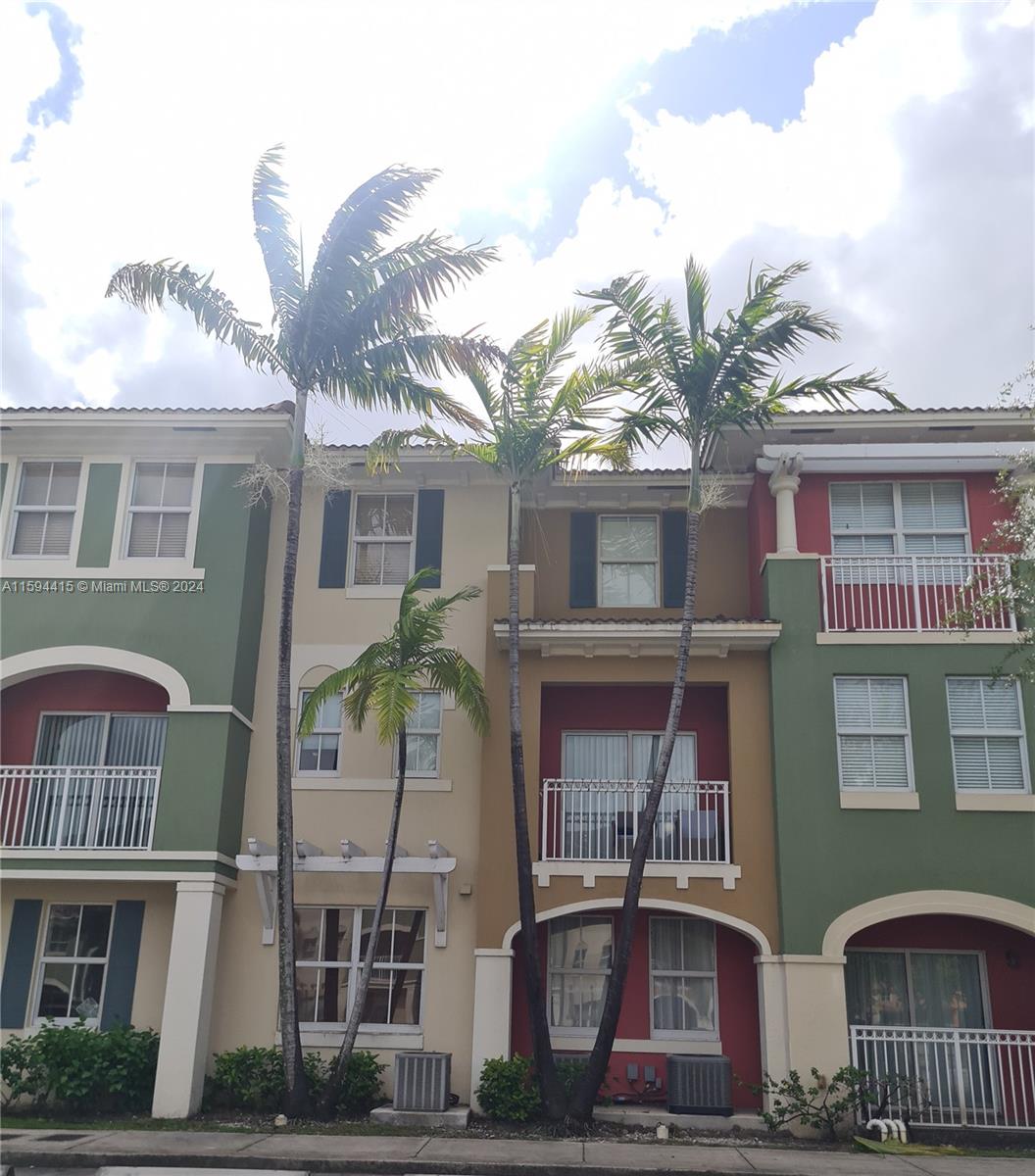 a front view of a residential apartment building with a yard