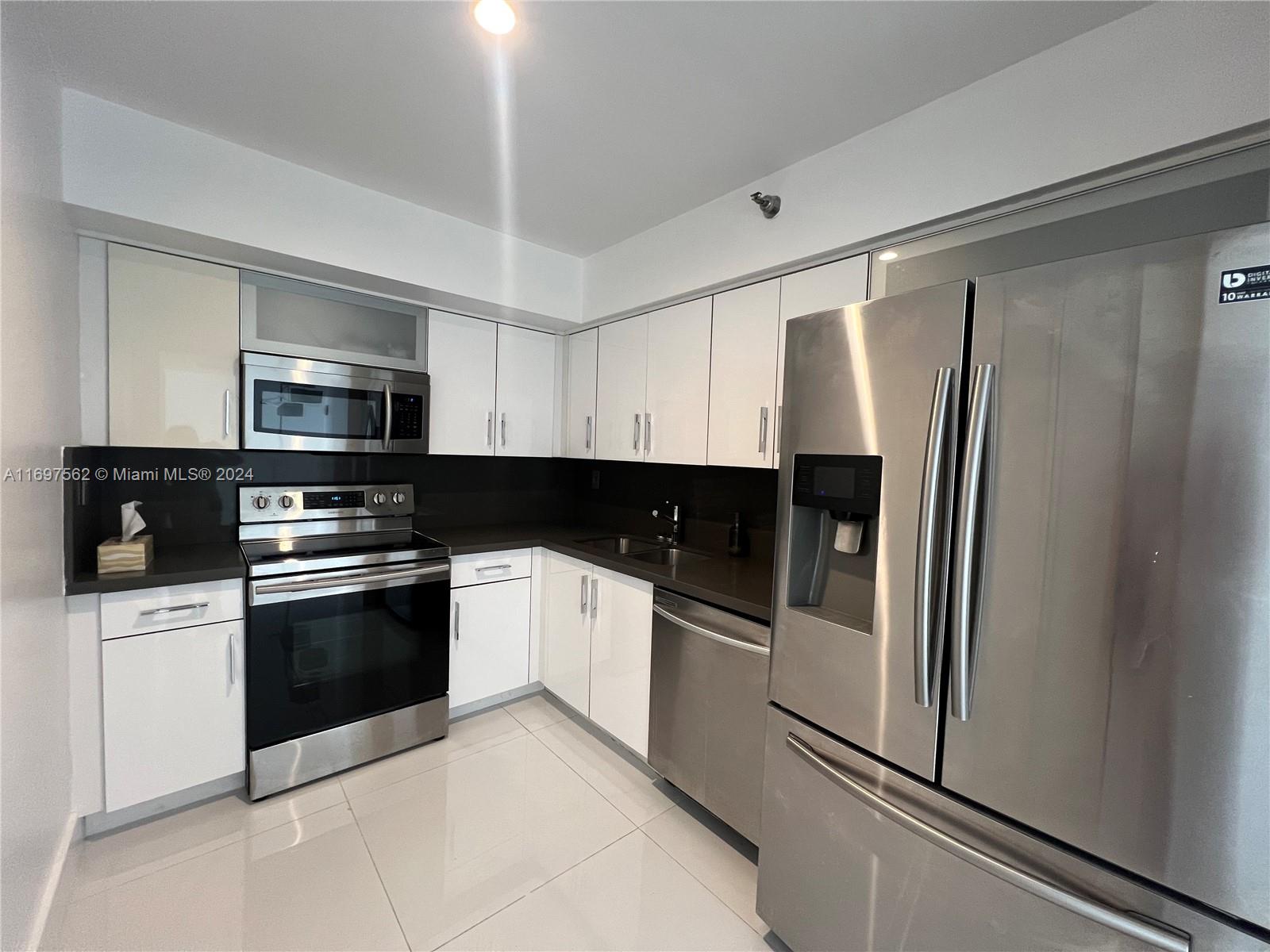 a kitchen with stainless steel appliances and granite countertop