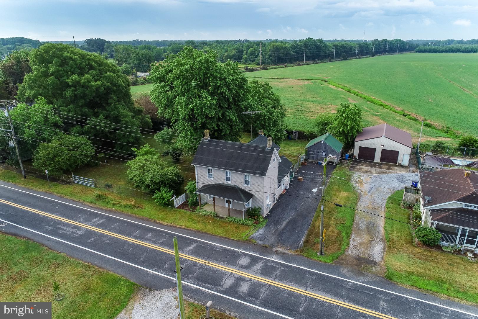 an aerial view of a house with a garden and trees