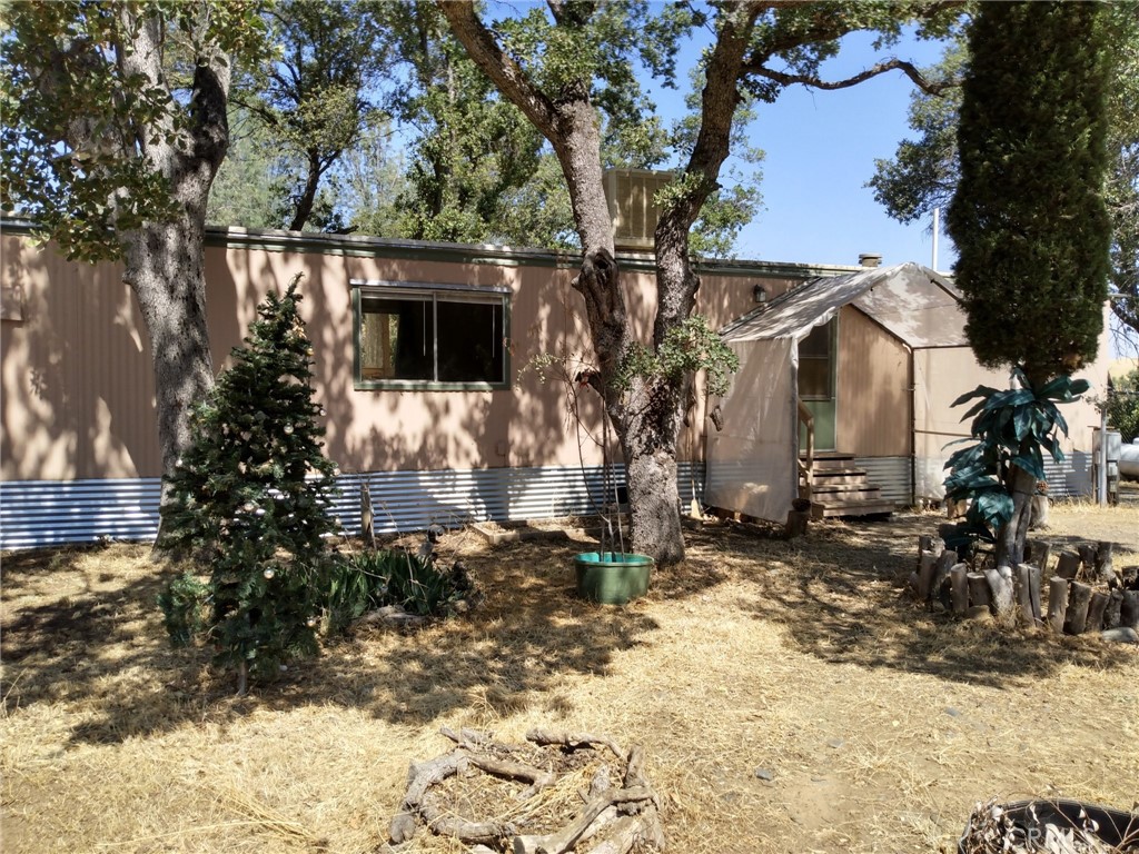 a view of a house with a yard covered in snow