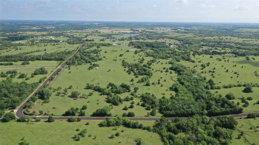 an aerial view of a houses with yard