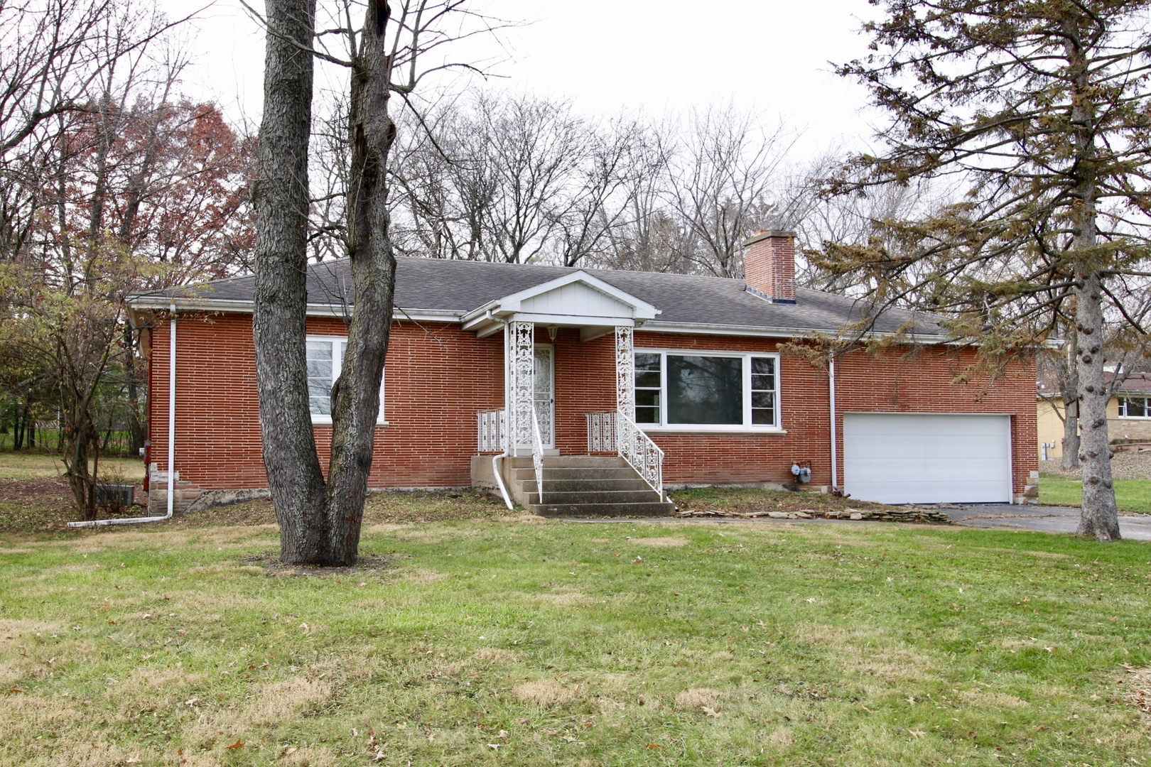 a front view of house with yard and green space