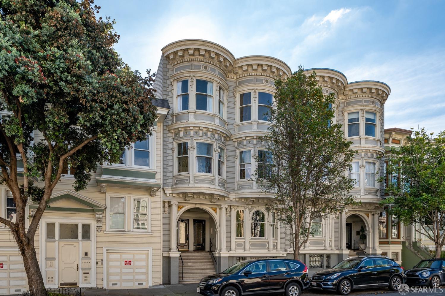 a front view of a residential apartment building with a yard