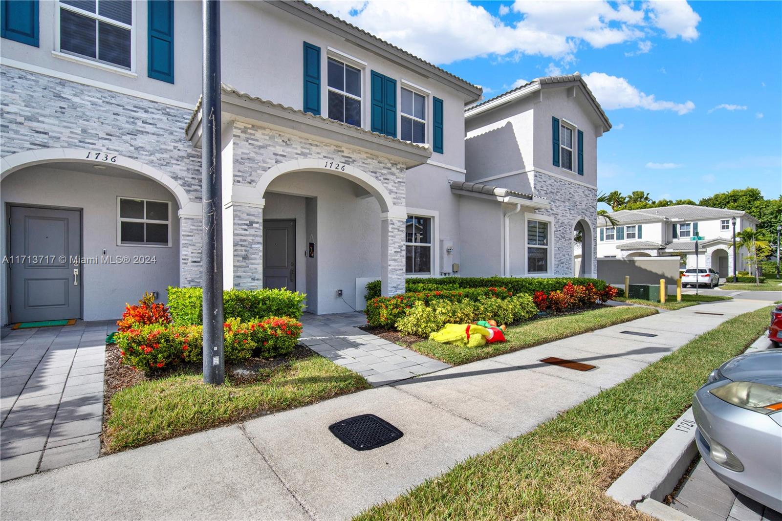 a front view of a house with a yard and outdoor seating