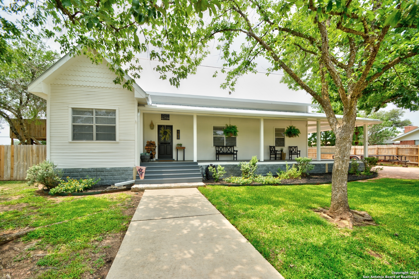 a front view of a house with garden and porch