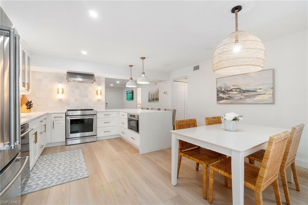 a kitchen with a stove a refrigerator and a fireplace