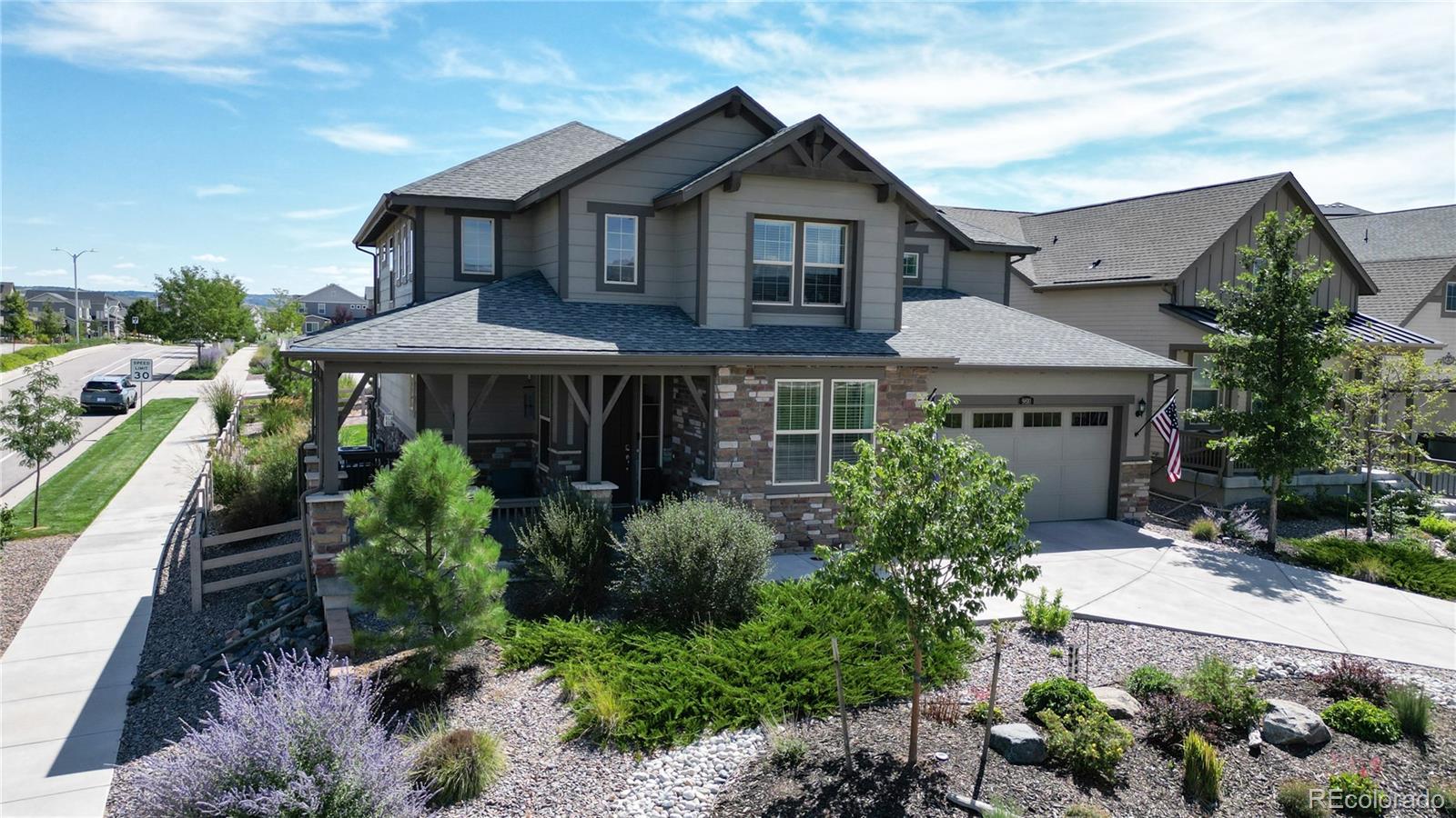 a front view of a house with yard and green space