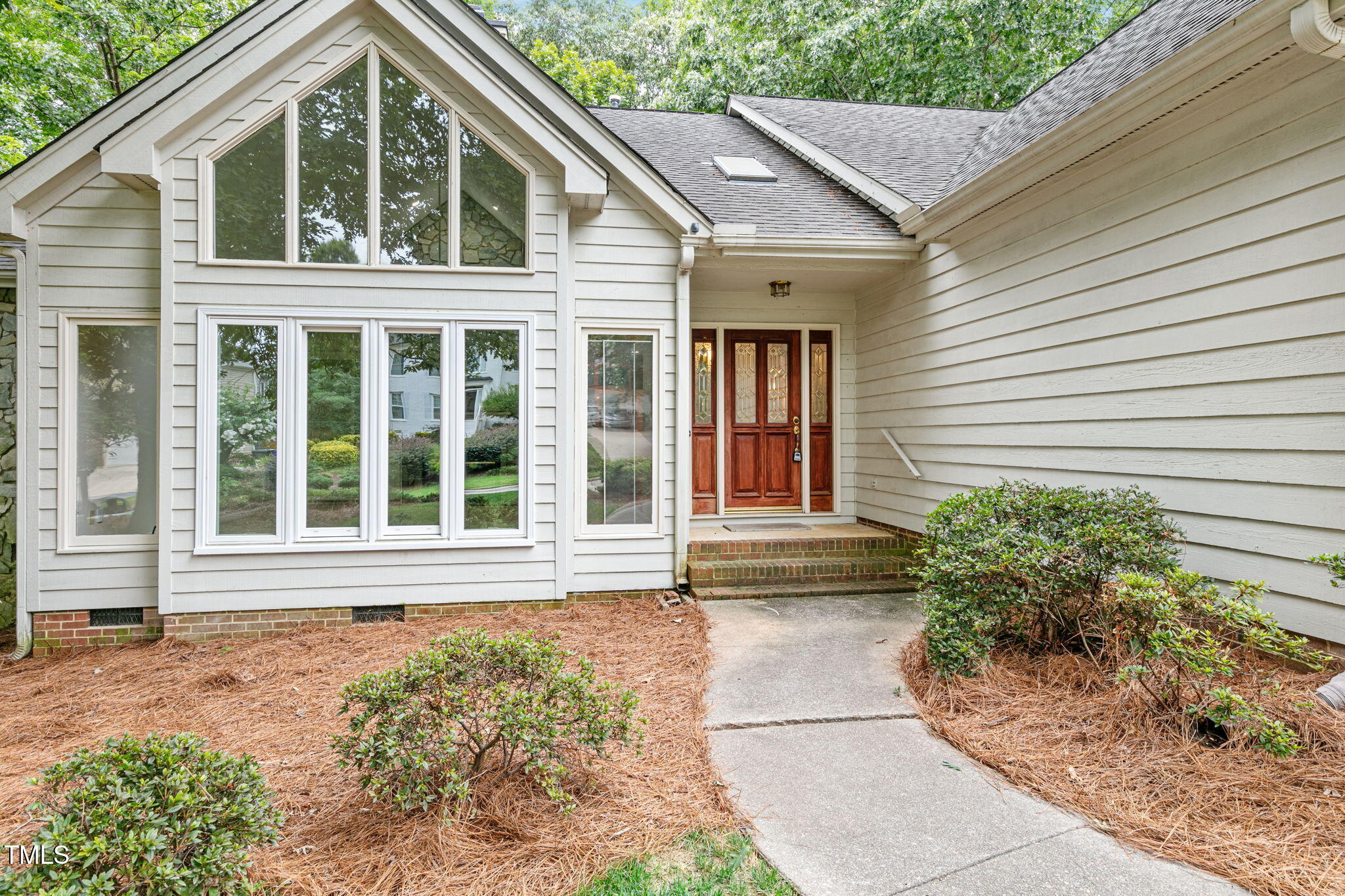 a front view of a house with garden