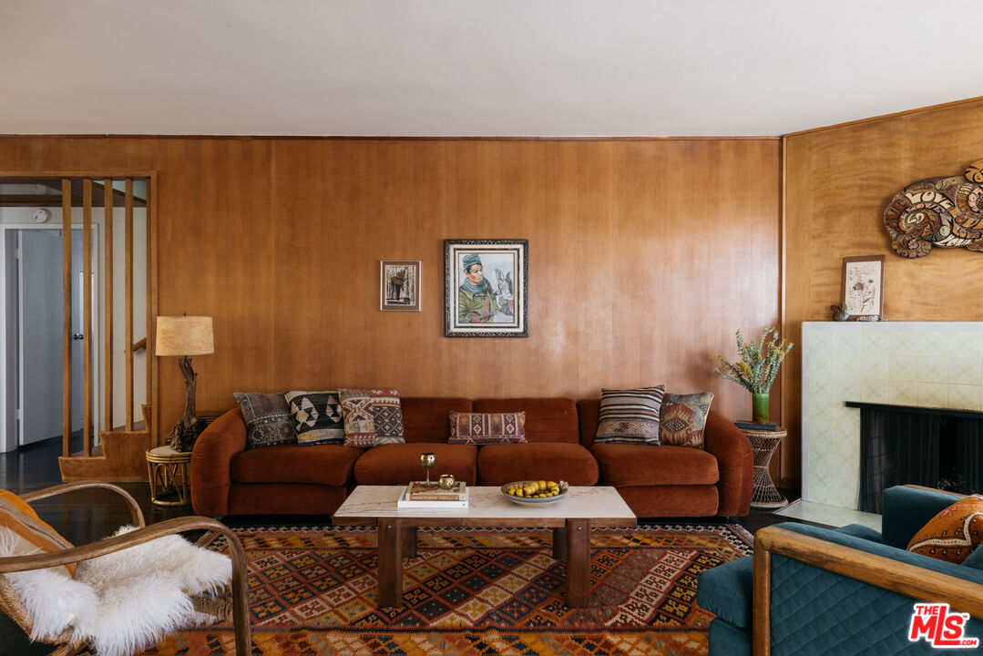 a living room with furniture a couch and a fireplace