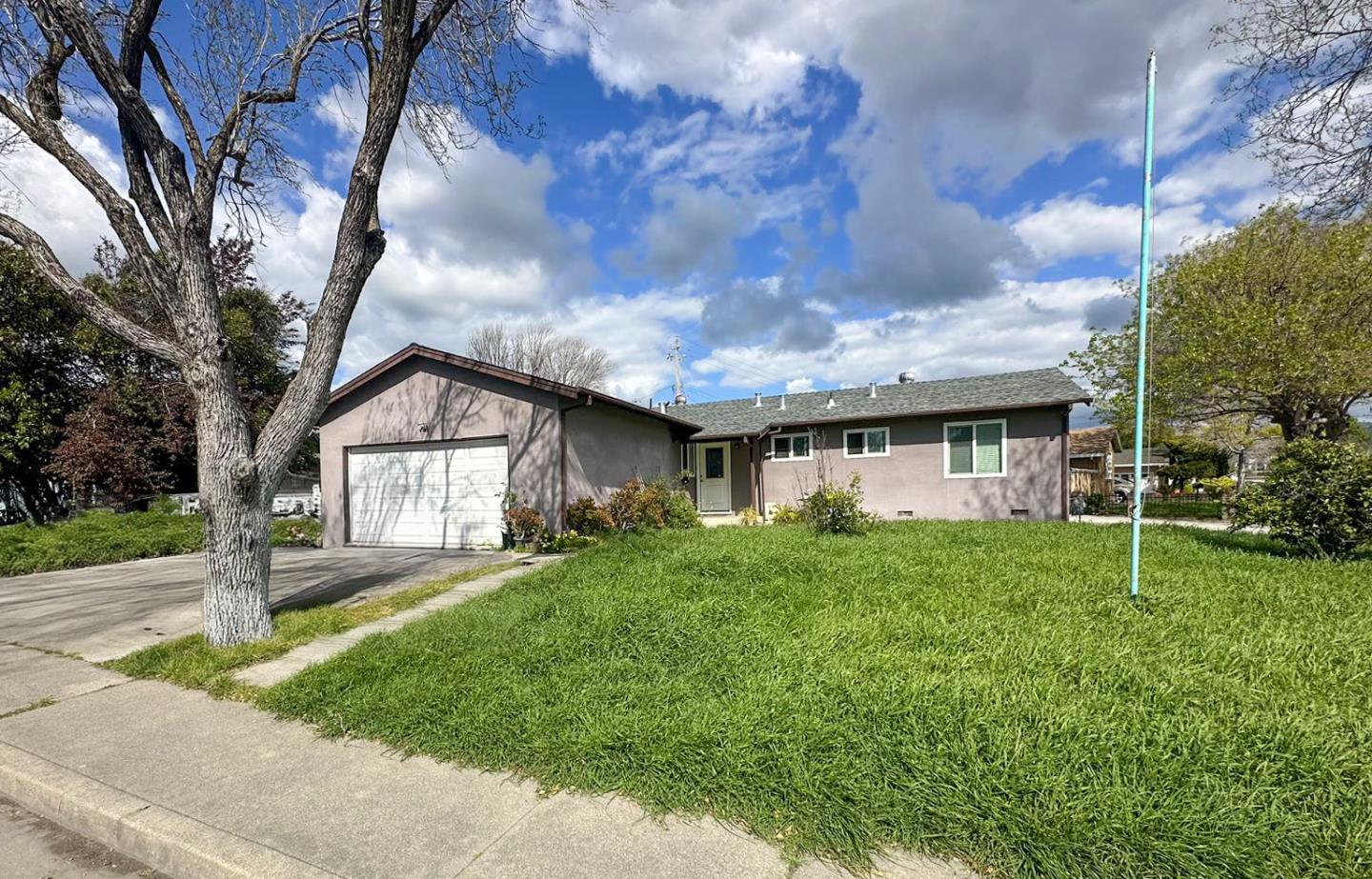 a front view of house with yard and green space