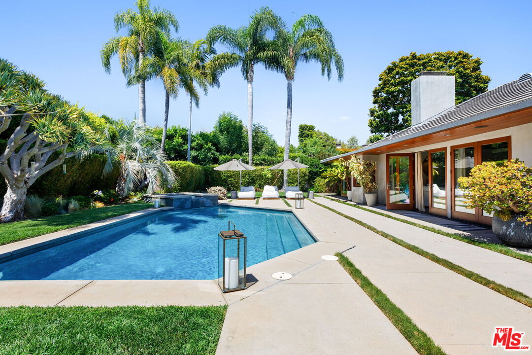 a view of a house with a yard and potted plants