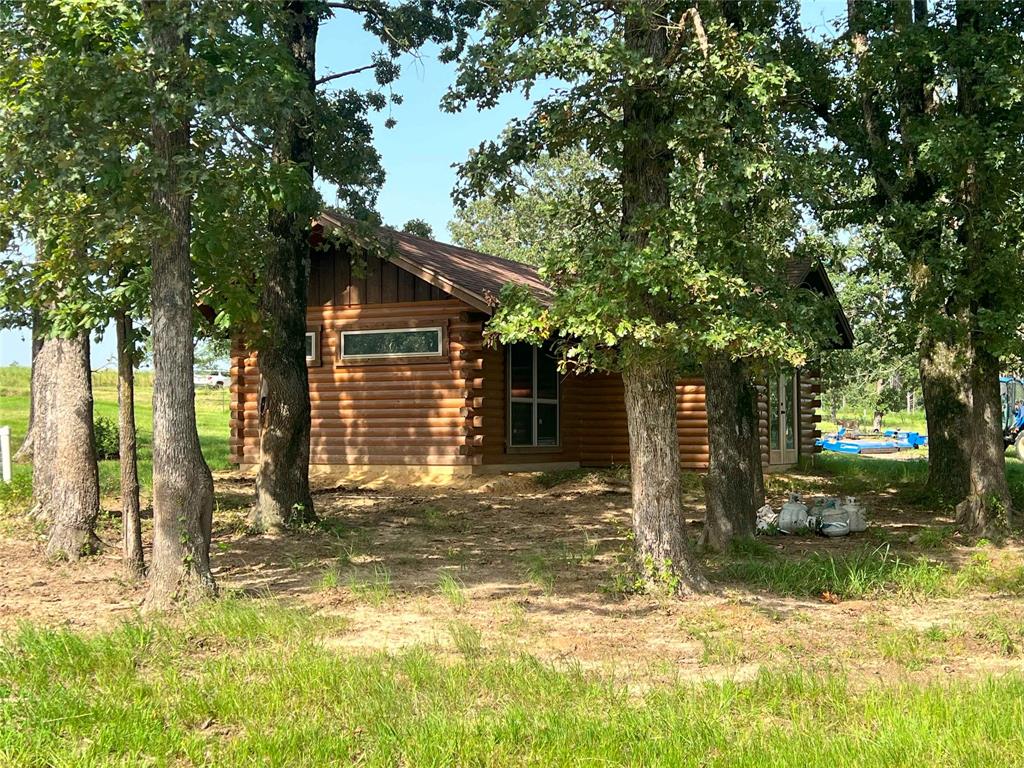 a view of a house with a tree in the yard