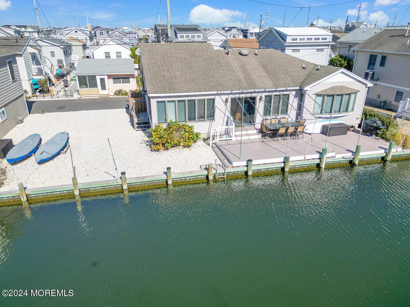 an aerial view of residential houses with outdoor space and swimming pool