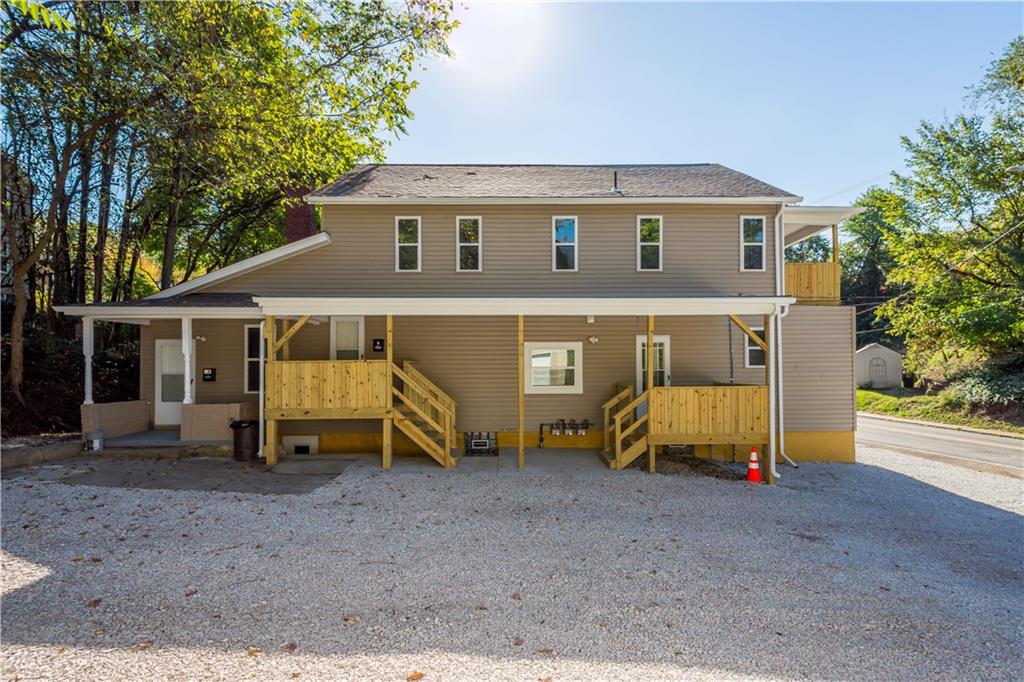 a view of a house with a yard and wooden fence