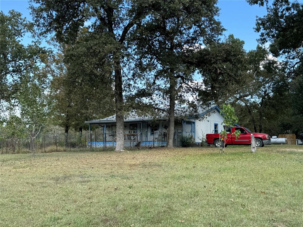 a view of a house with a yard and sitting area